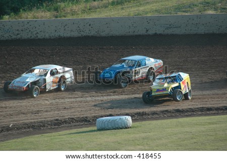 Modified cars racing on dirt track
