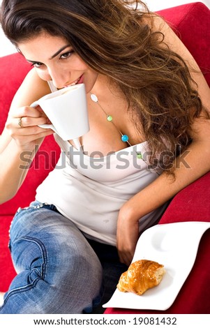 Beautiful smiling lady waking up and drinking coffee
