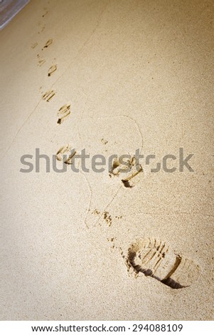Shoe footprints in the sand - vignette added