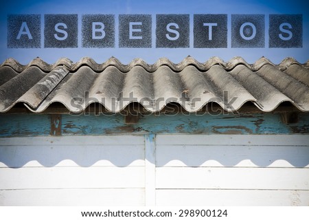 Dangerous asbestos roof.  The word asbestos written with letters whose graphic resembles the shape of the asbestos particles.