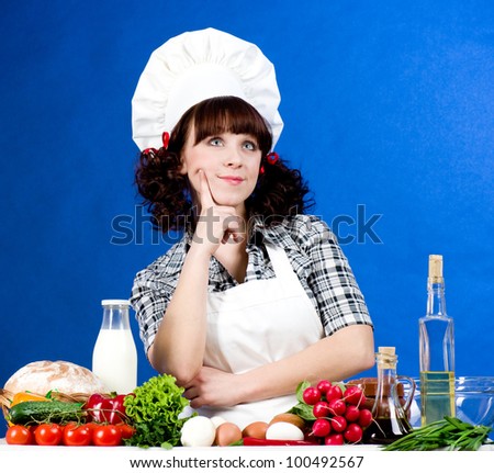 Smiling happy cook woman with food ingredients