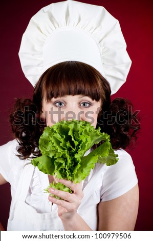 Smiling happy cook woman with green salad