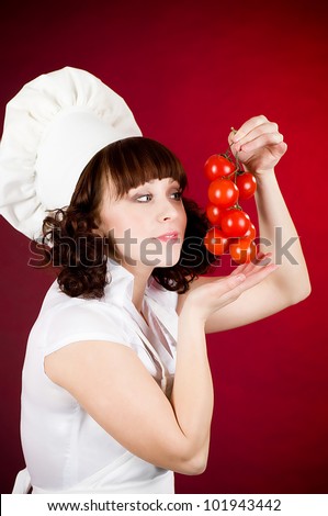 Smiling happy cook woman with red tomato