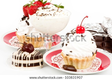 Dessert - sweet cake with strawberry and cherry on a plate on background