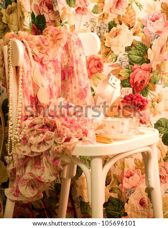 Vintage elegant dress and shoe, cup and raspberry on white chair
