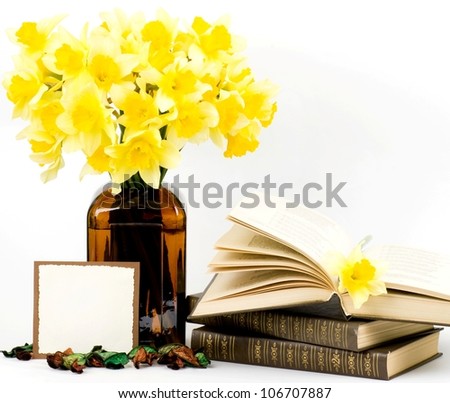 Beautiful spring flowers in a glass vase with banner add and book