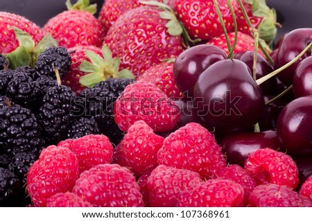 Berry Mix background - raspberries, mulberry, strawberry and cherry