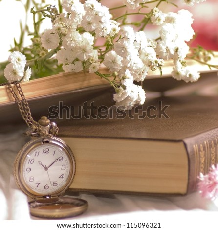 White flowers, book and clock
