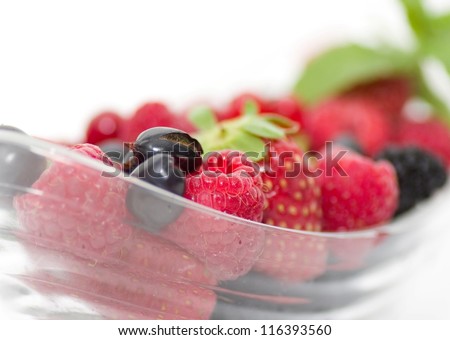 Dessert with fresh berry mix on a plate on background