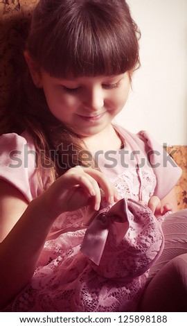 Beautiful little girl in pink dress in vintage style