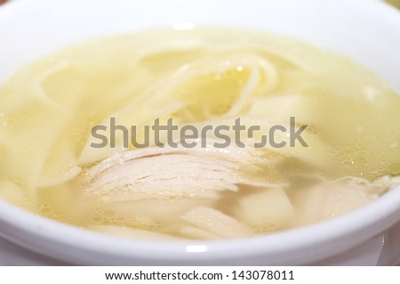 Tasty chicken clear soup with hen meat in plate