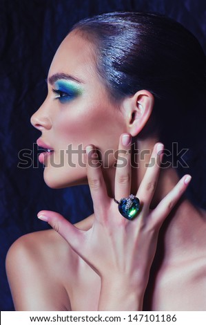 Portrait of beautiful young woman with makeup in luxury jewelry