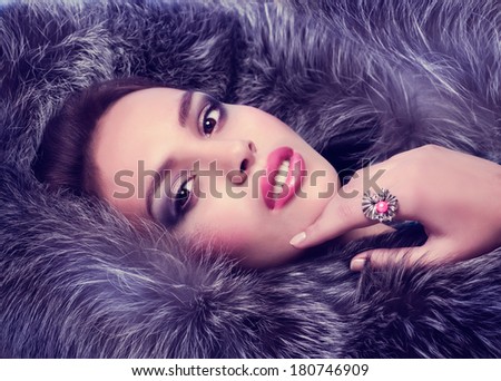 Portrait of beautiful young woman with makeup and with jewelry precious decorations.