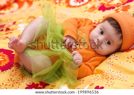 Cute little girl in orange clothes
