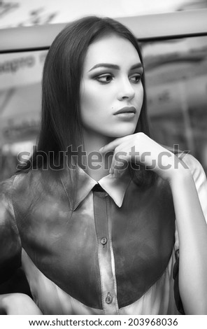 Portrait of beautiful young woman with makeup in fashion blue clothes