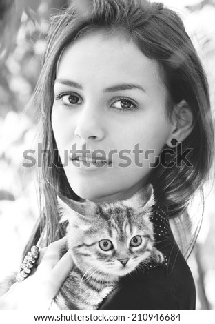 Surprised girl with a little cat