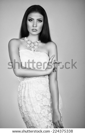 Fashionable young female in contemporary short dress. Studio shot