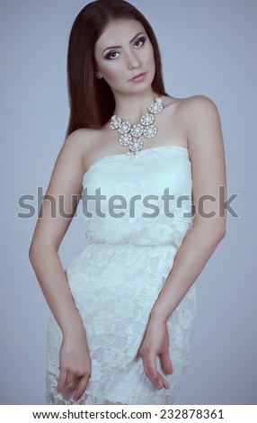 Fashionable young female in contemporary short dress. Studio shot