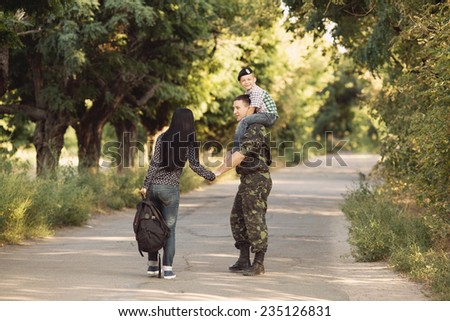 Family and soldier in a military uniform say goodbye before a separation