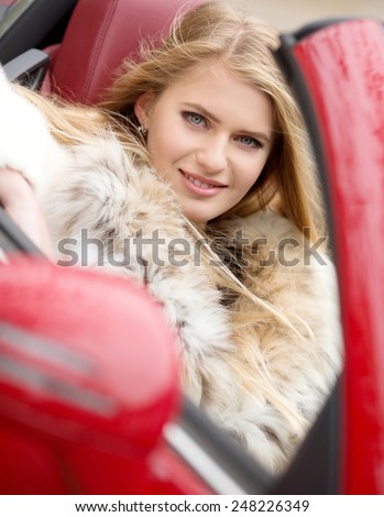 Portrait of beautiful young woman with makeup in fashion clothes in car