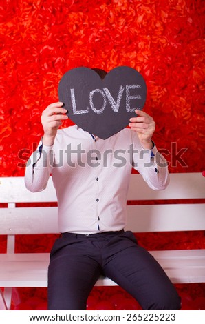Loving man with a tablet in form heart