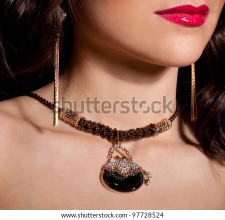 Portrait of a beautiful lady with golden jewelry