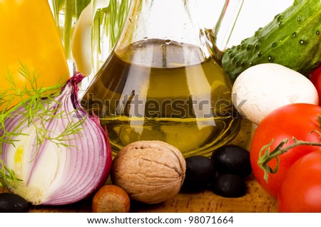 Olive oil and vegetables on a white background