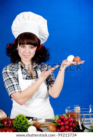 Smiling happy cook woman holds a easter eggs