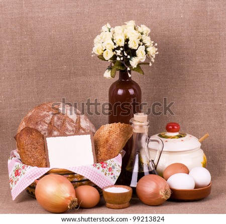 Tasty cakes and bread in basket, eggs, olive oil, eggs with banner add