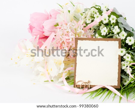Gold wedding rings with banner add and bouquet of flowers