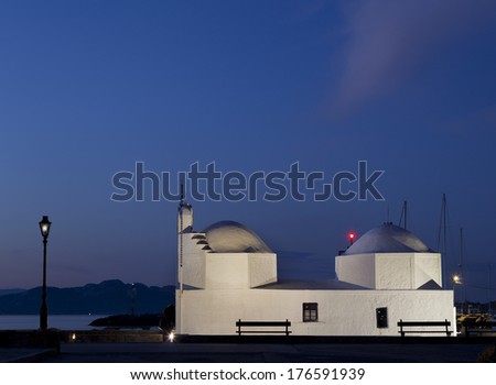 Night shot.Typical little white orthodox greek church in the harbor of Aegina, a little island in Saronic Gulf