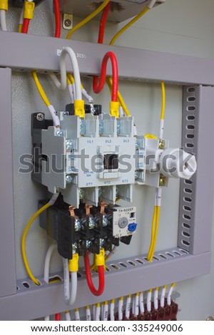 Power cable connected to a circuit breaker in the electrical cabinet.