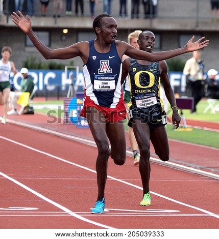Eugene, Oregon June 12, 2014 - Arizona\'s Lawi Lalang crosses the finish line a step ahead of Oregon\'s Edward Cheserek in the men\'s 5000m race at the 2014 NCAA Track & Field Championships