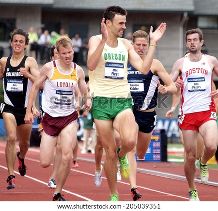 Eugene, Oregon June 12, 2014 - Mac Fleet of the University of Oregon claps his hands as he crosses the finish line in the men\'s 1500m preliminary heat at the NCAA Track & Field Championships