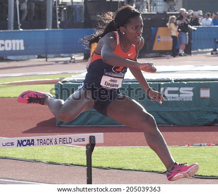 Eugene, Oregon June 12, 2014 - Jesica Ejesieme of the Univeristy of Illinois clears a hurdle in a preliminary heat of the women\'s 400m race at the 2014 NCAA Track & Field Championships