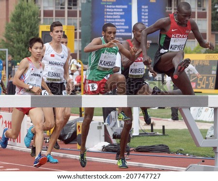 July 27, 2014 Eugene, Oregon - Kenyan teammates Barnabus Kipyego and Titus Kipruto Kibiego and Ethiopia\'s Maresa Kahsay clear the  steeplechase barrier at the 2014 IAAF Junior World Championships