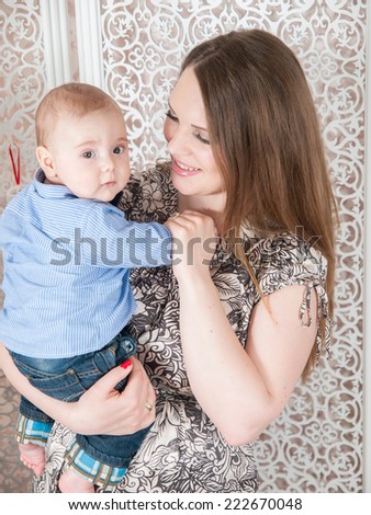 Beautiful woman holding a baby. Mother and son. Family Portrait.