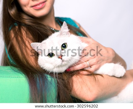 Portrait of a smiling girl sitting and hugging cat. Selective Focus.