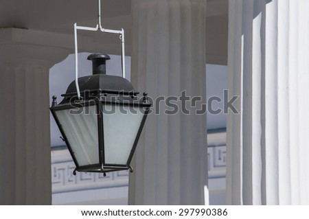 Simple lantern in classical Greek temple with columns on the background