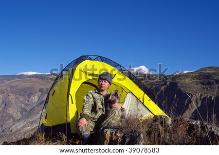 Tourist and his dog Relaxing in the yellow tent