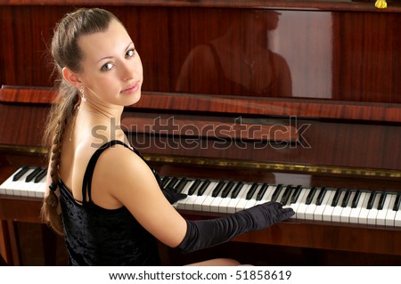 Beautiful young female pianist playing some melody