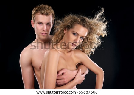 stock photo Beautiful naked couple with curly hair over black background