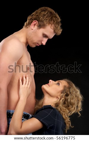 stock photo Beautiful naked couple in love over black background