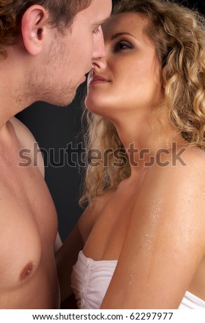 stock photo Closeup portrait of young naked couple in love over black 