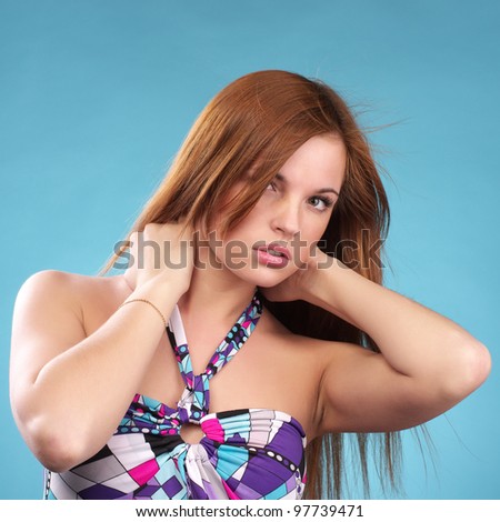 Young fashion woman in sundress against blue background