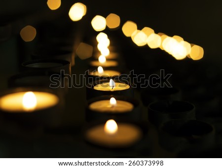 Candles in a row. Bokeh of tea light candle