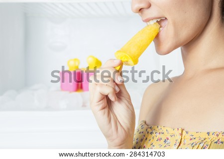 Beautiful woman eating ice cream. Woman cooling off with ice cream in summer