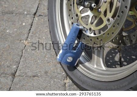 Wheel of a motorbike locked with a padlock