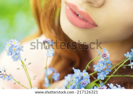 big sexy lips girls with blue flowers in her hands