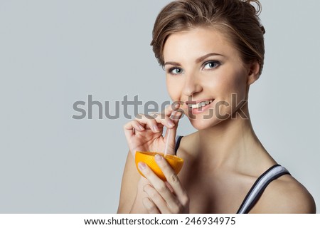 beautiful young athletic girl energetic happy drinking orange juice, healthy lifestyle